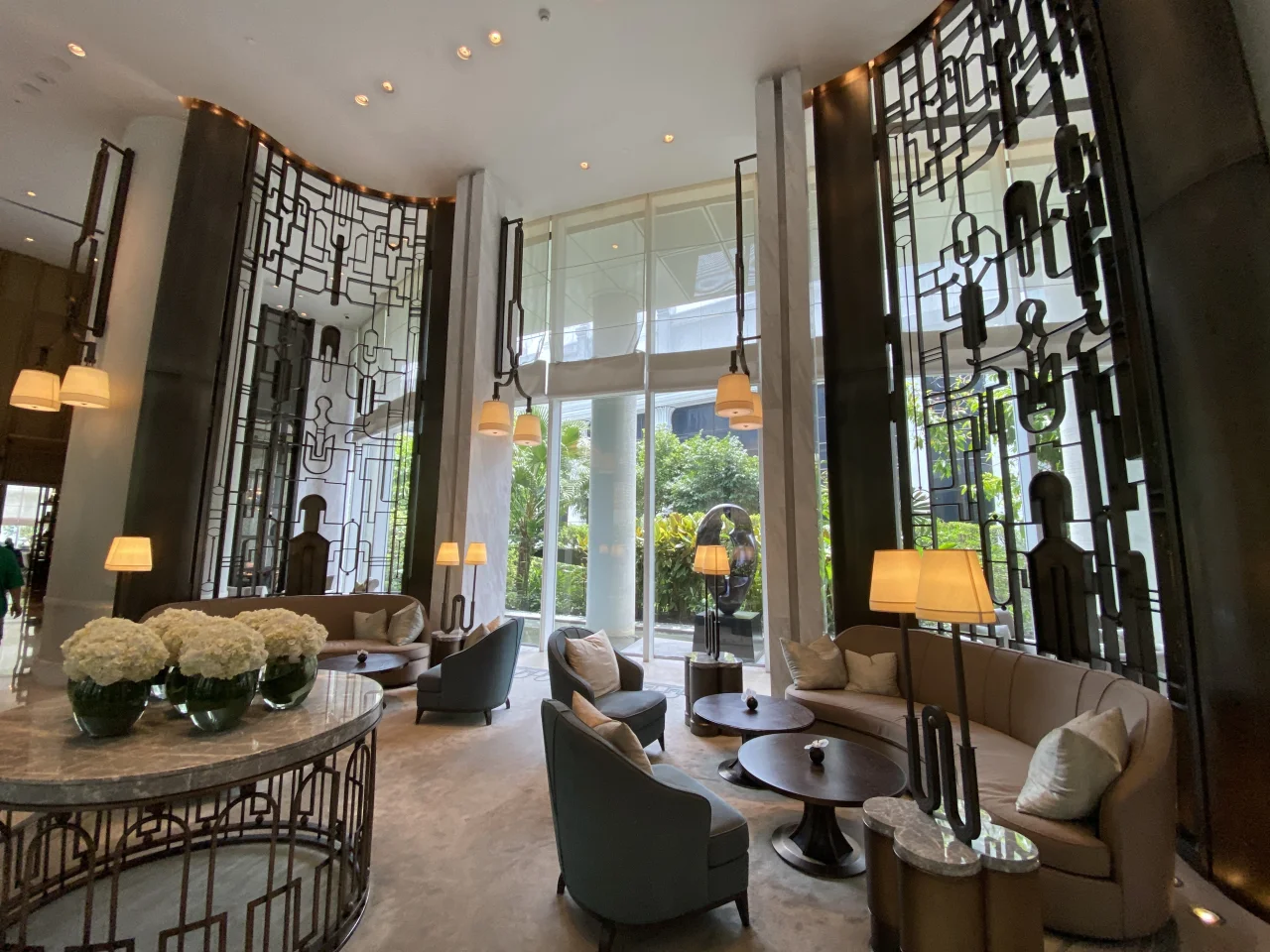 Lobby lounge at Waldorf Astoria Bangkok with decorative metal screens and armchairs